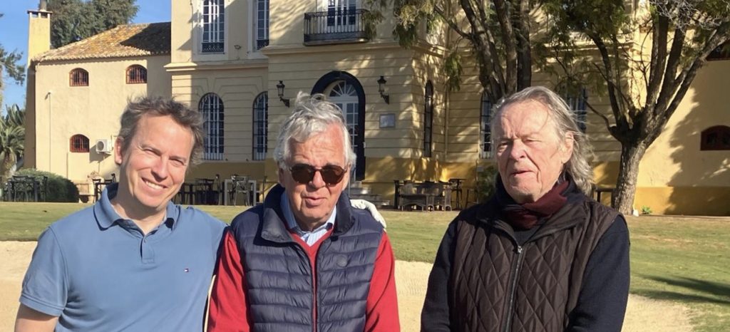 Sam with his dad and his uncle, standing together on a golf course